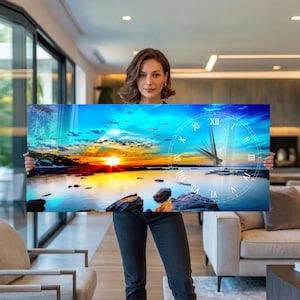 Pode incluir: Um relógio de parede retangular com um pôr do sol sobre a água. O mostrador do relógio, com algarismos romanos e ponteiros, é sobreposto à imagem. O céu transita do azul para o laranja e amarelo.