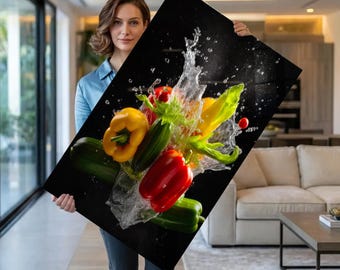 May include: A vibrant canvas print featuring a dynamic arrangement of fresh vegetables. The artwork showcases red, yellow, and green bell peppers, cucumbers, and other produce, with water splashing around them against a black background. A striking piece for kitchen or dining decor.