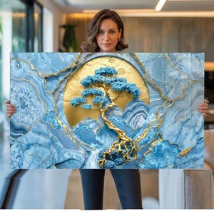 May include: A rectangular wall art piece featuring a central golden circular sun motif behind a textured blue bonsai tree with gold branches. The surrounding background displays a blue and white agate stone pattern with gold vein accents.