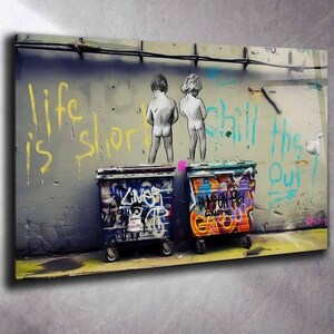 Tempered Glass Wall Art featuring two children above colorful graffiti-covered dumpsters against a distressed urban wall with bold yellow and turquoise writing. Urban Street Art ideal for industrial, loft and contemporary interiors.
