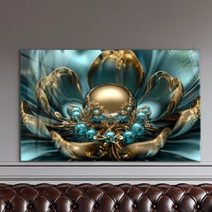 May include: A digital art print featuring a stylized flower with a large golden sphere at its center. The petals are teal and gold, with smaller teal orbs and intricate gold detailing. The artwork is displayed on a wall above a brown leather couch.