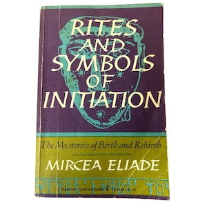 May include: A vintage paperback book titled "Rites and Symbols of Initiation" by Mircea Eliade. The cover features a teal face graphic on a purple background, with white text. The book's title and author are prominently displayed.