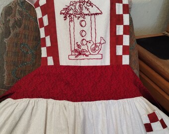 Vintage handmade long apron with pretty embroidered bird on front bib  and pocket
