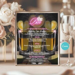 May include: A framed bar menu with a gold border, featuring a neon pink "the Bar" logo and drink options. The menu includes signature cocktails, beer, wine, spirits, and non-alcoholic beverages. Two cocktail glasses are visible.