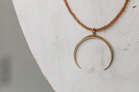 Bronze crescent moon and bead necklace