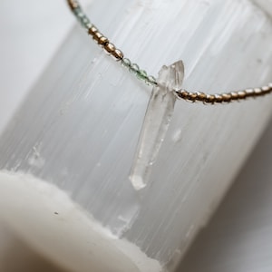 Raw rock quartz crystal and blue tourmaline stones, glass beads, healing stone, energy