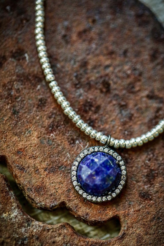 Stunning lapis lazuli, black gold, and cubic zirconia necklace