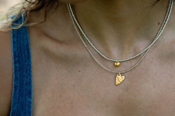 Tiny puffed gold heart charm and hammered heart necklaces