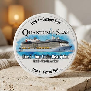 May include: A white, round item with a cruise ship illustration and the text "QUANTUM OF THE SEAS." The design includes text fields for customization: "Line 1 - Custom Text," "Line 2 - Your Cruise Description," "Line 3 - Your Custom Text," and "Line 4 - Custom Text."