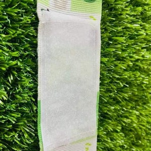 May include: A white fabric wristband with a euro bill design. The wristband has a white velcro closure.