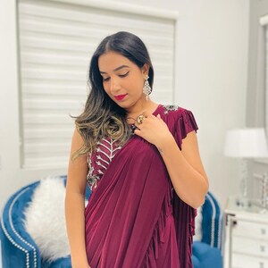 Purple lycra fabric stitched saree with heavy embroidery blouse in stretchable fabric which gives you very nice fit.