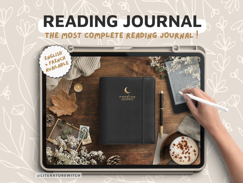 May include: A black leather-bound reading journal with a gold crescent moon and the words "reading journal" on the cover. The journal is on a wooden table with a cup of coffee, a pen, and an e-reader.