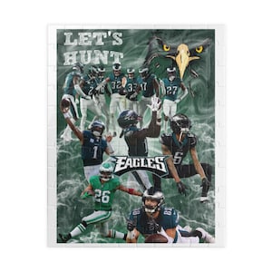 May include: A green and white jigsaw puzzle featuring a collage of Philadelphia Eagles football players in action. The puzzle includes the team's logo and the words "Let's Hunt".