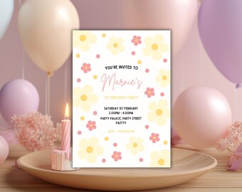 May include: A floral-themed invitation for Marnie's 1st birthday party. The invitation features yellow and pink flowers, with text that reads "You're invited to Marnie's 1st Birthday Party". The invitation is on a wooden tray with a lit candle and balloons.
