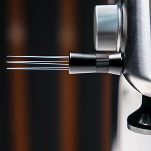 May include: Close-up of a black fiber optic cable connector with four multi-colored fibers extending from the end.
