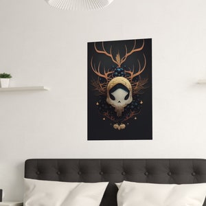 May include: A black and gold skull with antlers and floral accents on a dark background. The skull is surrounded by a wreath of leaves and berries.