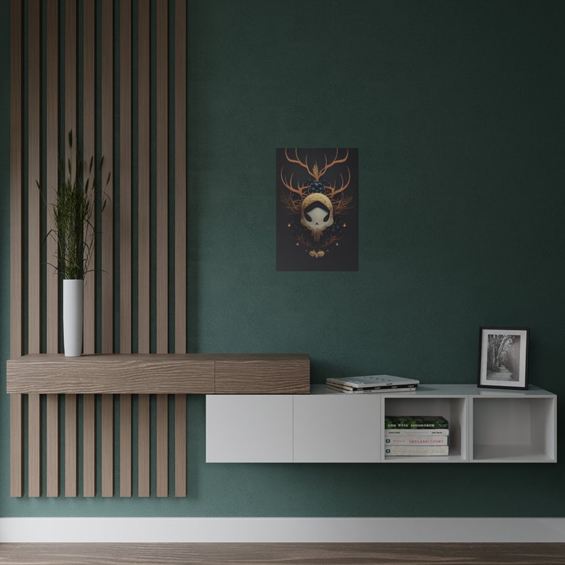 May include: A white floating shelf unit with two open compartments and a closed compartment. The shelf is mounted on a teal wall. The shelf is decorated with books, a framed photo, and a framed print of a skull with antlers and foliage.