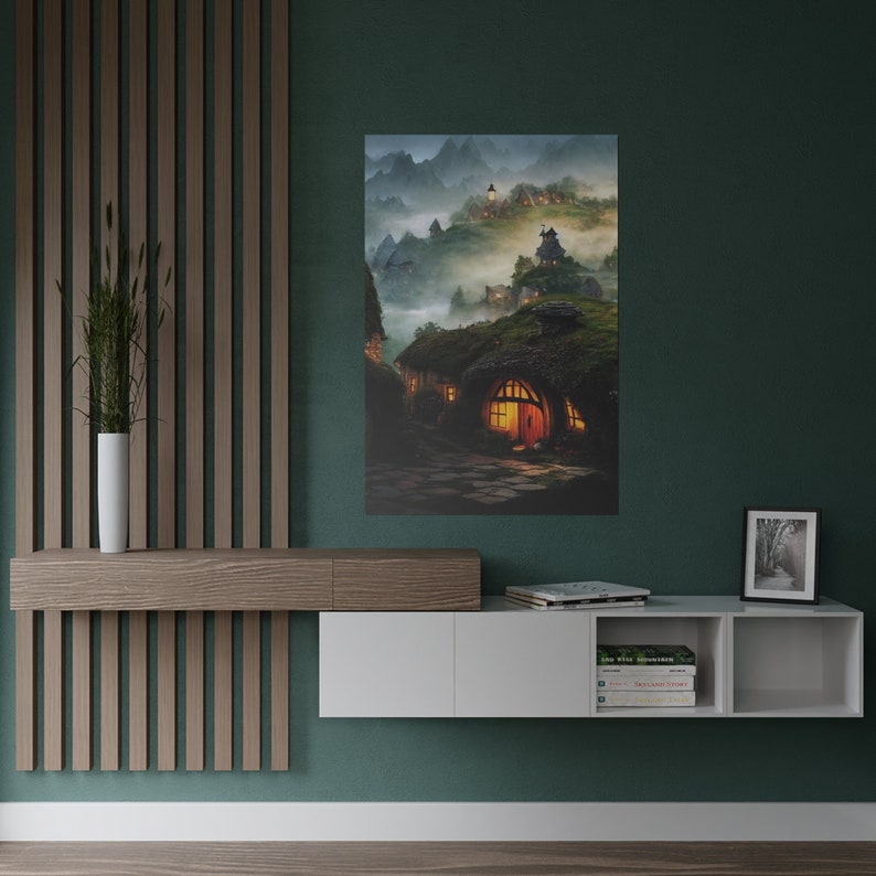 May include: A canvas print depicting a fantasy village nestled in a misty mountain landscape. The artwork features cozy hobbit-hole-like homes with glowing windows and thatched roofs, evoking a sense of warmth and tranquility. The color palette includes greens, browns, and warm yellows.