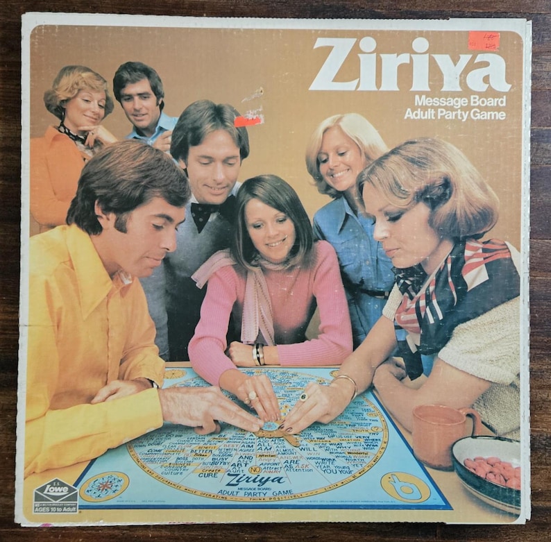 May include: A vintage Ziriya Adult Party Game box. The box has a brown background with the game title in white. The image shows a group of people around a blue game board with text and illustrations. The game is for ages 18 and up.