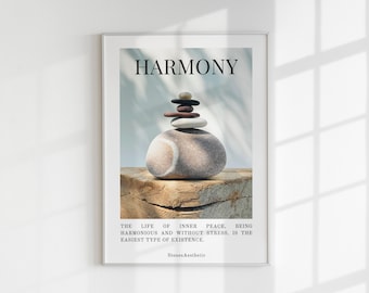 May include: A framed print with a white background and a stack of grey, brown, and white stones on a wooden surface. The text "HARMONY" is at the top of the print, and the text "THE LIFE OF INNER PEACE. BEING HARMONIOUS AND WITHOUT STRESS, IS THE EASIEST TYPE OF EXISTENCE." is at the bottom of the print. The text "Stones Aesthetic" is at the very bottom of the print.