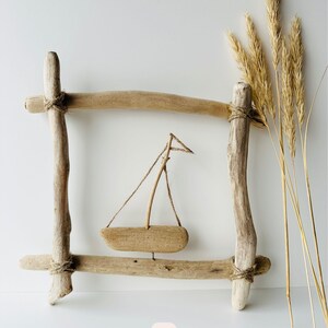 Natural driftwood wall decor with minimalist sailboat accent, rustic maritime wall hanging