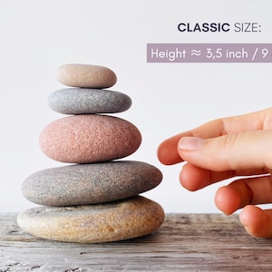 May include: A stack of five smooth, rounded river stones in varying shades of tan, gray, and pink. The stones are arranged vertically from largest at the base to smallest at the top. Text indicates a classic size with a height of 3.5 inches.