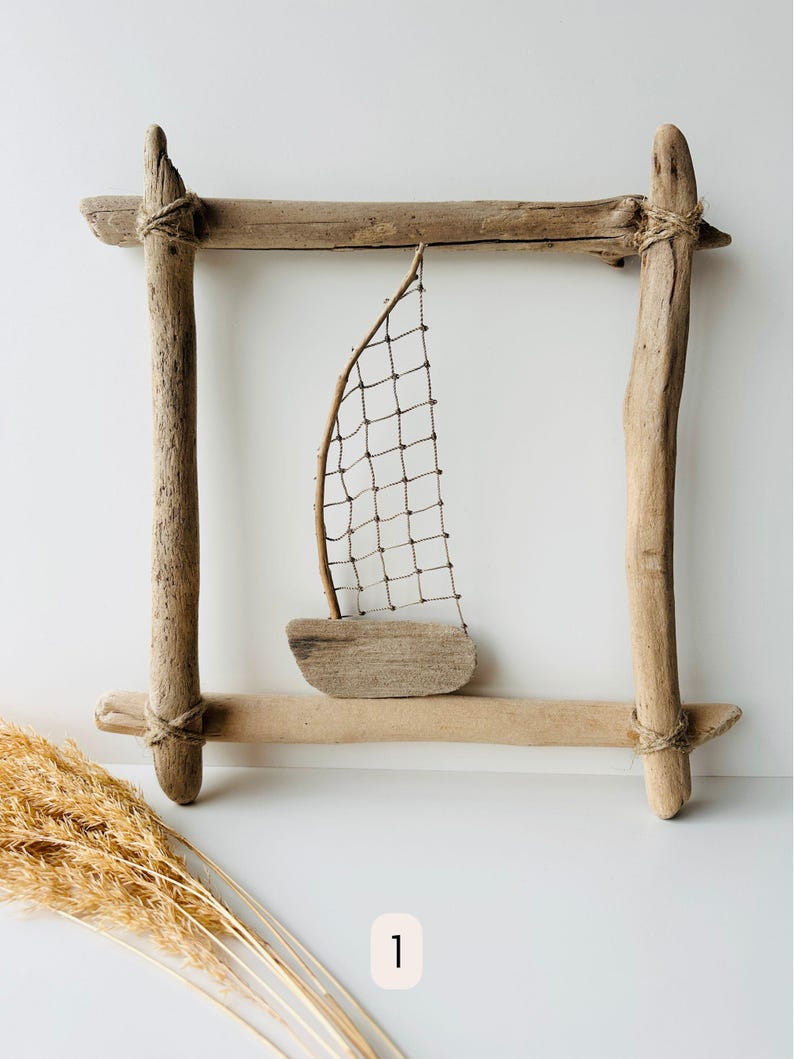 Handmade driftwood wall hanging with sailboat design, nautical coastal wall decor made from natural wood, rope, and netting