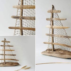 Puede incluir: Escultura de velero de madera flotante con acabado de madera natural. La escultura presenta un m&aacute;stil de madera con listones horizontales de madera y una vela de red. La base es un trozo de madera flotante. El n&uacute;mero "31" est&aacute; en la esquina superior izquierda.