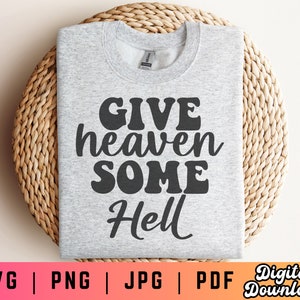 May include: A gray sweatshirt with the text "Give heaven some hell" printed in black.