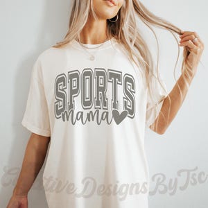 May include: A white t-shirt with the text "SPORTS mama" in gray with a gray heart.