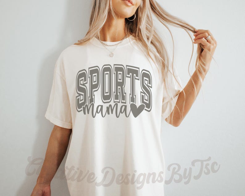 May include: A white t-shirt with the text "SPORTS mama" in gray with a gray heart.