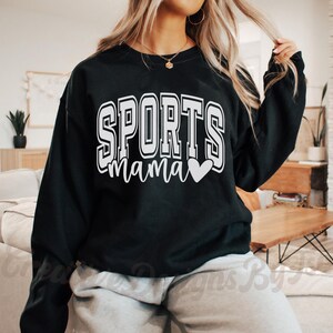 May include: Black sweatshirt with white text that reads "SPORTS mama" with a small white heart.