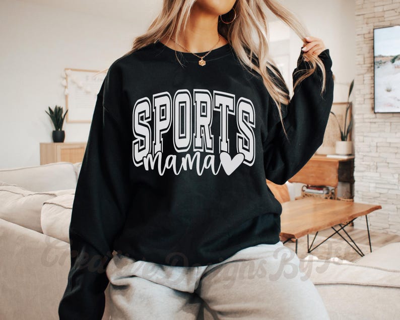 May include: Black sweatshirt with white text that reads "SPORTS mama" with a small white heart.