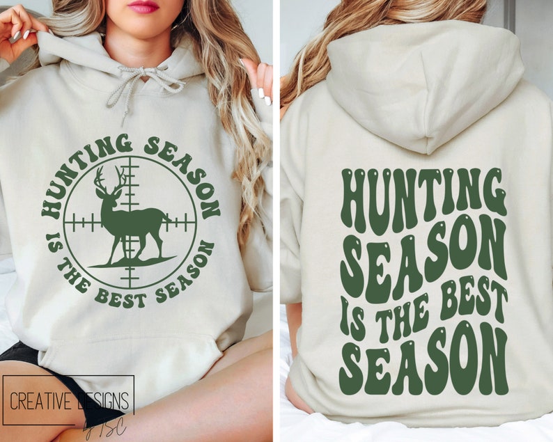 May include: A beige hoodie with the text "HUNTING SEASON IS THE BEST SEASON" in green. The front features a deer inside a crosshair circle. The back of the hoodie also displays the same text in a retro font.