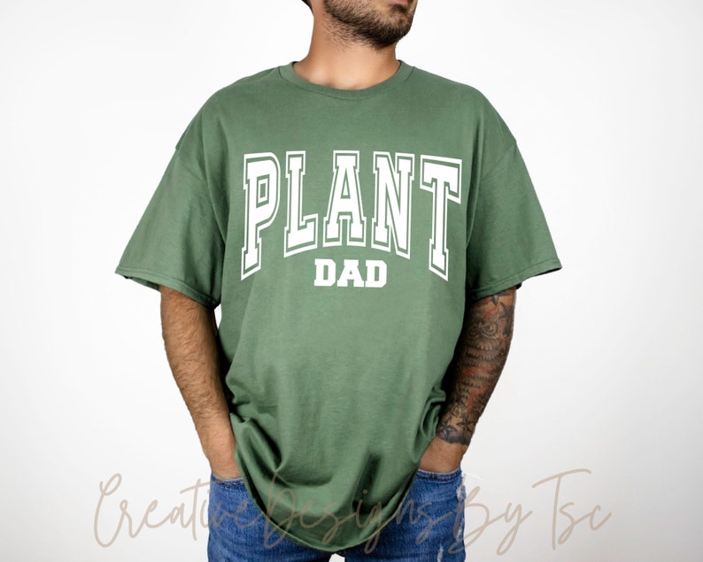 May include: A green t-shirt with the text "PLANT DAD" in white letters.