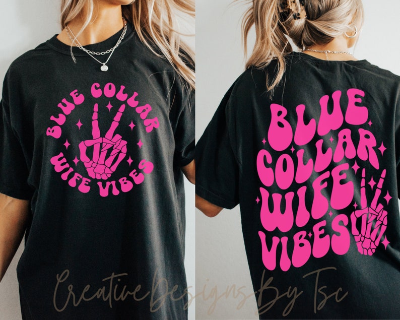 May include: Black t-shirt with a pink graphic that says "Blue Collar Wife Vibes" with a skeleton hand making a peace sign.