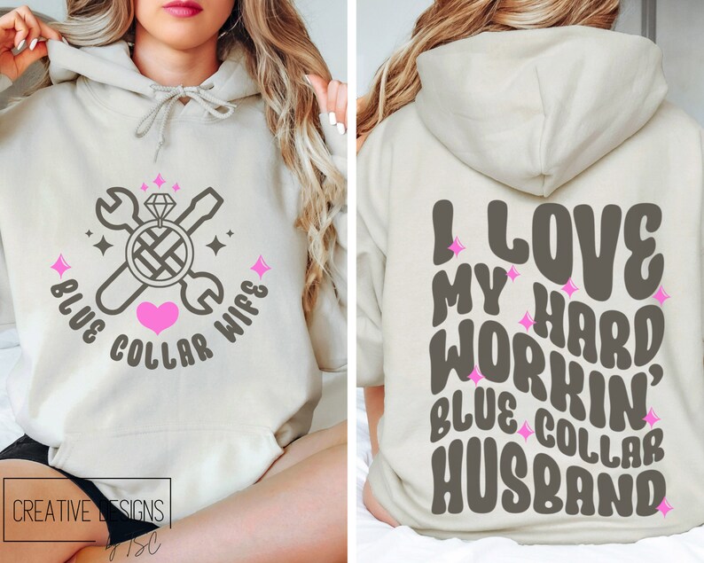 May include: A light beige hoodie with a graphic design on the front and back. The front design features a wrench, screwdriver, and a diamond ring with the text "Blue Collar Wife". The back design features the text "I Love My Hard Workin' Blue Collar Husband".