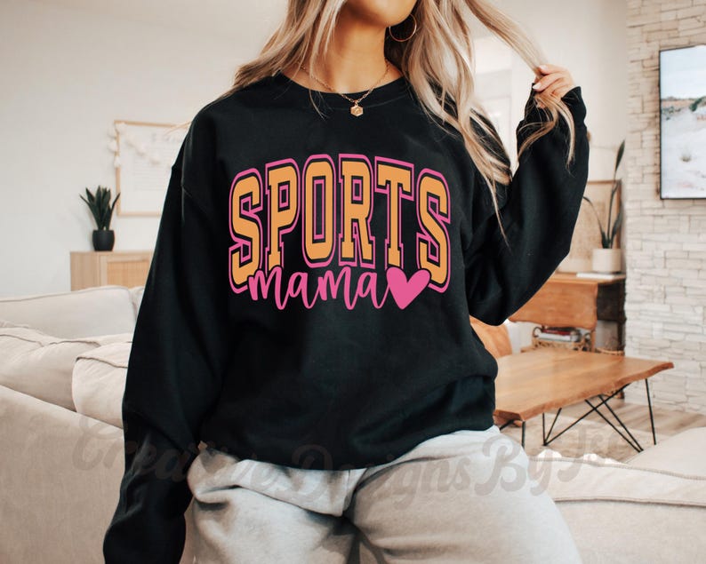 May include: Black sweatshirt with the text "SPORTS mama" in yellow and pink letters with a pink heart.