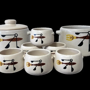 May include: Set of six white ceramic soup bowls with a brown, black and yellow design of a fork, spoon and ladle. The set includes a larger bowl with a lid.