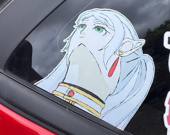 May include: A vinyl decal sticker featuring an anime-style character with long, pale blue hair, pointed ears, and green eyes. The character wears a white collar with gold trim and a small red circular accent, looking upward with a neutral expression.