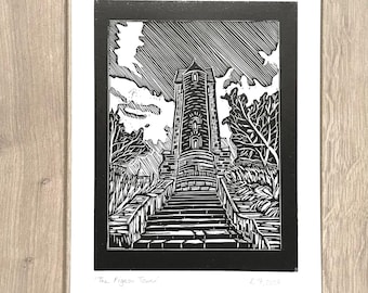 May include: Black and white linocut print of a tower with steps leading up to it. The print is titled "The Pigeon Tower".