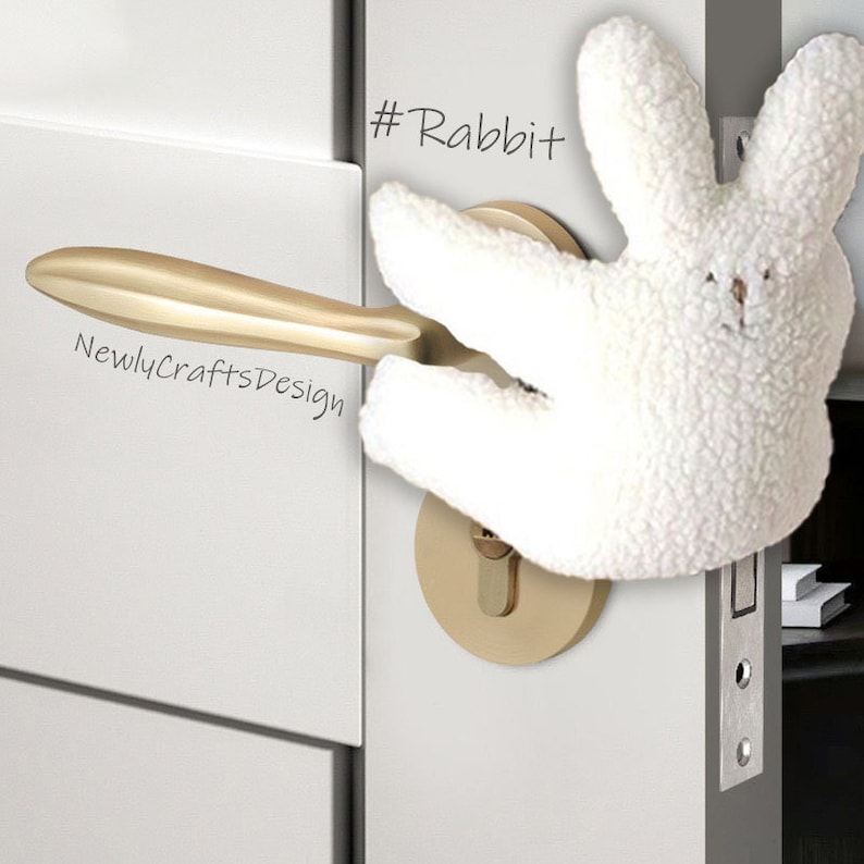 May include: A white plush rabbit hand puppet is holding a gold door handle. The door handle is attached to a white door. The text "#Rabbit" is written on the door.