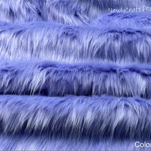 May include: Close-up of a soft, blue faux fur fabric. The fabric has a long pile and is perfect for crafting projects.  Color #22.