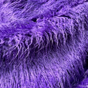 May include: Purple shaggy faux fur fabric with a long pile. The fabric is soft and fluffy, and it has a luxurious feel.