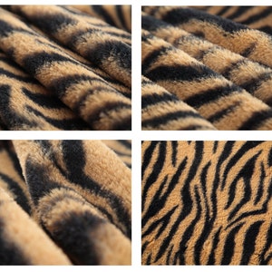 May include: Close-up of a brown and black faux fur fabric with a tiger stripe pattern.