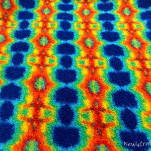 May include: A colorful fabric with a rainbow tie-dye pattern. The fabric has a fuzzy texture and is perfect for crafting projects. #6 NewlyCraftsDesign
