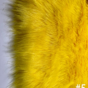 Puede incluir: Primer plano de una tela de piel sintética de color amarillo brillante. La tela tiene una textura suave y esponjosa. La imagen incluye el texto "#5 NewlyCraftsDesign".