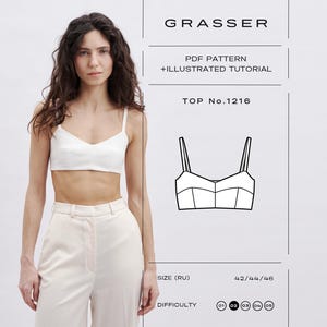 May include: A woman wearing a white crop top and cream-colored pants. The image includes a diagram of a top with thin straps, and the text "GRASSER", "PDF PATTERN + ILLUSTRATED TUTORIAL", and "TOP No.1216". The size is listed as 42/44/46, and the difficulty is indicated by a series of circles.