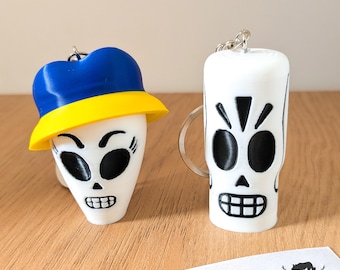 Manni Calavera and Mercedes Colomar keychain set. Grim Fandango inspiration.