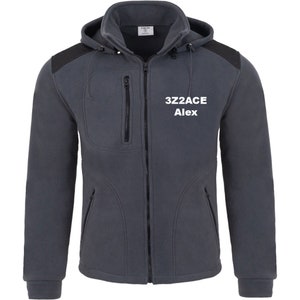 May include: A dark grey fleece jacket with a black zip and black accents on the shoulders and hood. The jacket has two zipped pockets on the front and a drawstring hood. The text "3Z2ACE Alex" is embroidered on the front of the jacket in white.